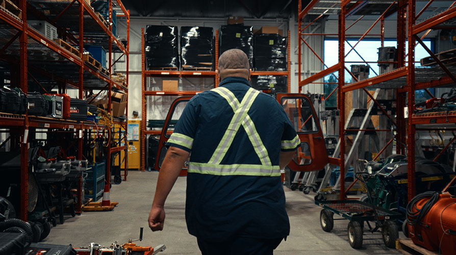 Man walking through Jobsite equipment warehouse
